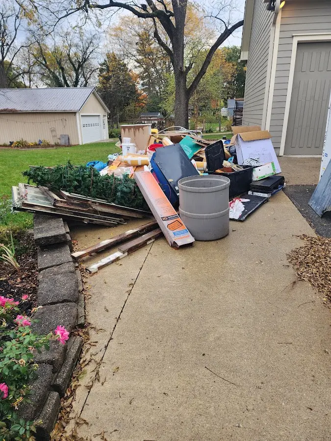 Dumpster being loaded with debris for 12 Yard Dumpster Rental in Tustin
